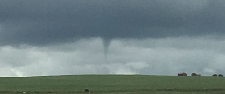 A funnel cloud is spotted near Airdrie, Alta. on July 16, 2016.