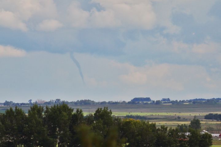 A funnel cloud is spotted near Beiseker, Alta. on July 16, 2016.
