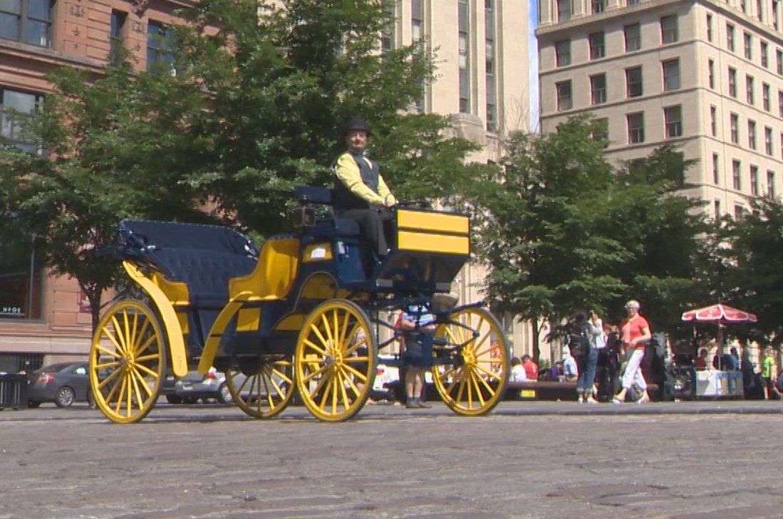 Jacques Prud'homme on his electric, horseless calèche in Montreal's Old Port, Tuesday, July 19, 2016.