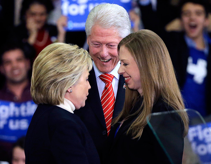 In this Feb. 9, 2016 file photo, Democratic presidential candidate Hillary Clinton huddles with her husband, former President Bill Clinton and daughter Chelsea at her New Hampshire presidential primary campaign rally in Hooksett, N.H.  