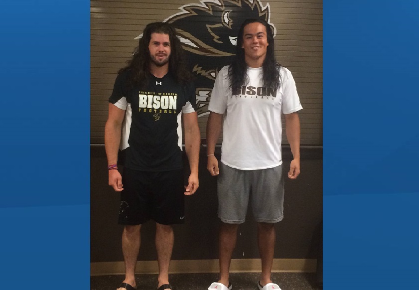 Bison football players Cam Fox (left) and Adam Neiles (right) pose just before cutting their hair for CancerCare Manitoba .