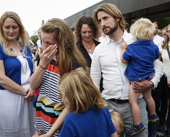 Collet Stephan, second from left, wipes away a tear as she and her husband David Stephan arrive at the courthouse with their children in Lethbridge, Alta., on June 24, 2016. 