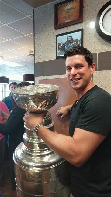 Pittsburgh Penguins' Sidney Crosby poses with the Stanley Cup inside a local Tim Horton's in his hometown of Cole Harbour, N.S., in a July 15, 2016, handout photo.