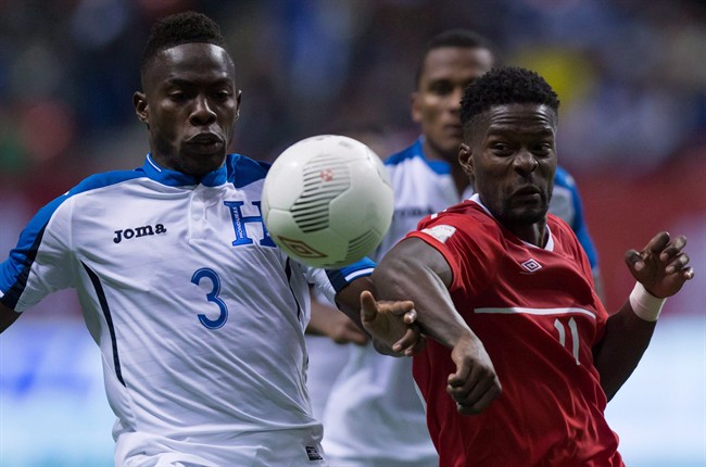 Honduras' Maynor Figueroa, left, and Canada's Tosaint Ricketts vie for the ball during second half CONCACAF 2018 World Cup qualifying soccer action in Vancouver on November 13, 2015.