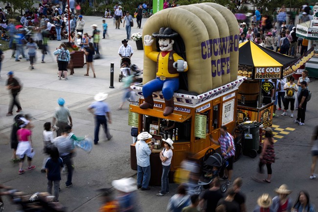 An inflatable cowboy looks out over visitors at the Calgary Stampede in a July 6, 2014, file photo.
