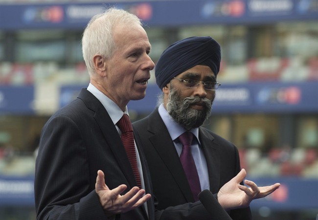 Canadian Minister of National Defence Harjit Sajjan listens as Foreign Affairs Minister Stephane Dion responds to a question at the NATO summit in Warsaw, Poland on July 9, 2016.