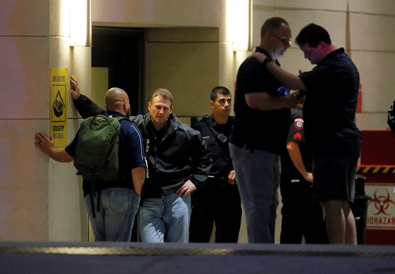 Law enforcement officials wait outside the emergency room entrance at Baylor University Medical Center, Friday, July 8, 2016, in Dallas. Snipers opened fire on police officers in the heart of Dallas on Thursday night, killing some of the officers. 