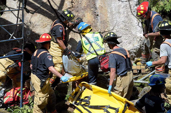 Emergency crews evacuate a man trapped under a slab of concrete at a dam in Hamilton on July 21, 2016. 