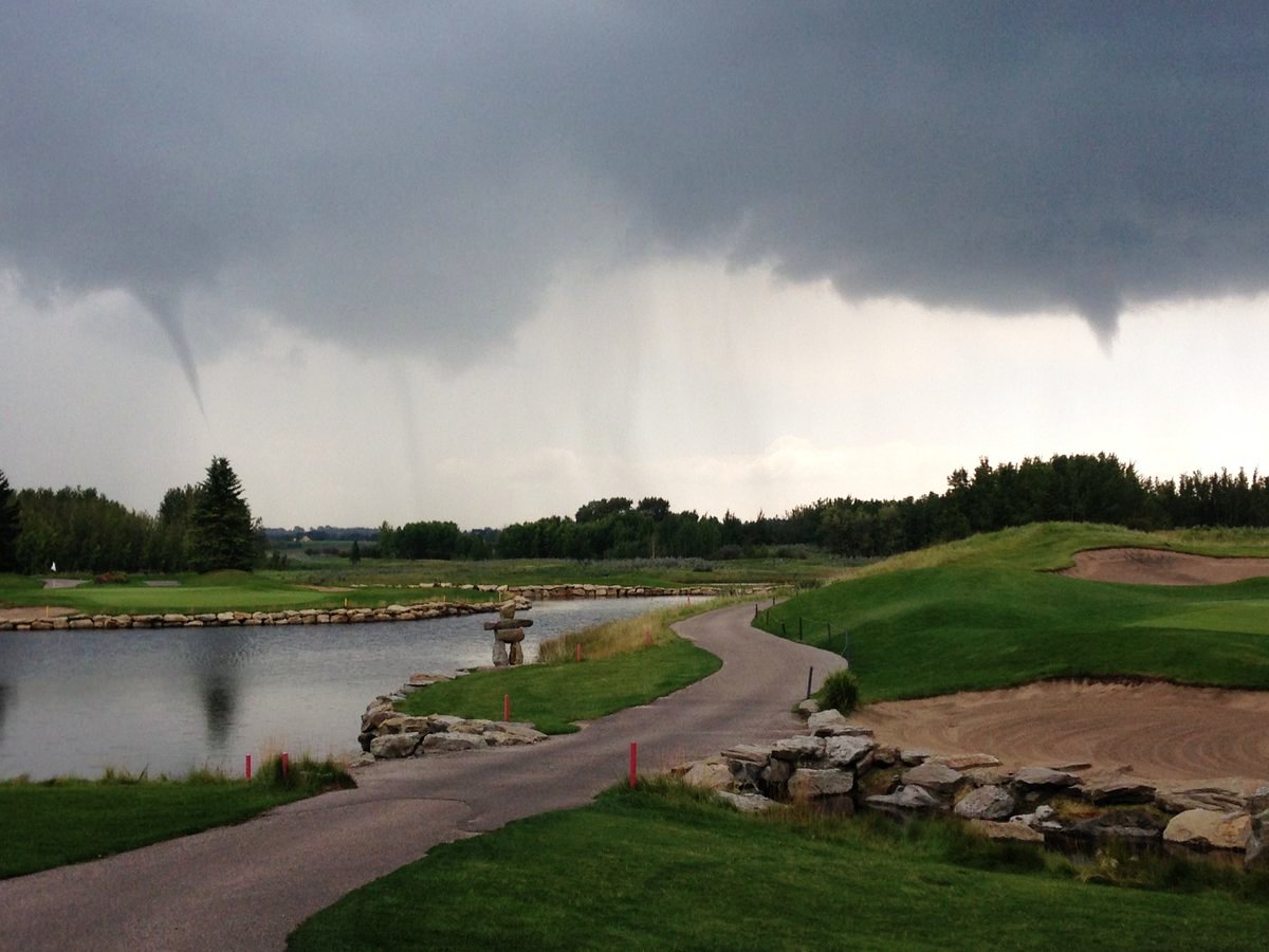 Funnel clouds can be seen over the Carnmoney Golf & Country Club in De Winton, Alta. on Sunday, July 17, 2016.