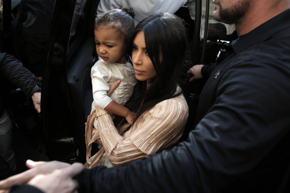 U.S. reality TV star Kim Kardashian carries her daughter North West.