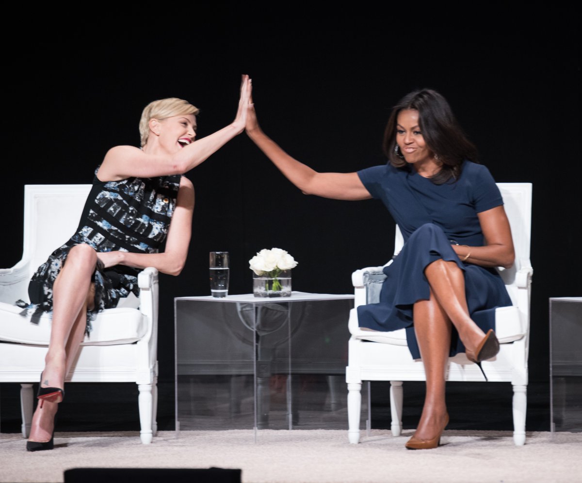 Charlize Theron (L) and First Lady of the United States Michelle Obama high five their awesomeness at the  "Let Girls Learn" Global Conversation at The Apollo Theater in 2015.