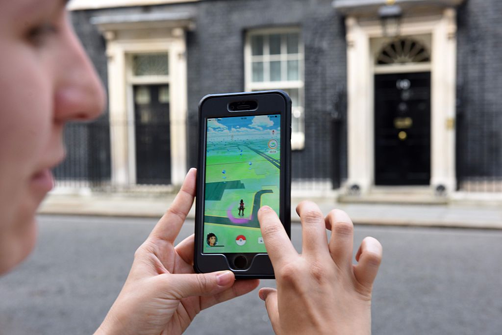 A picture taken on July 14, 2016 shows an avatar on the screen of a mobile phone as a player uses the Pokemon Go application on their mobile phone.