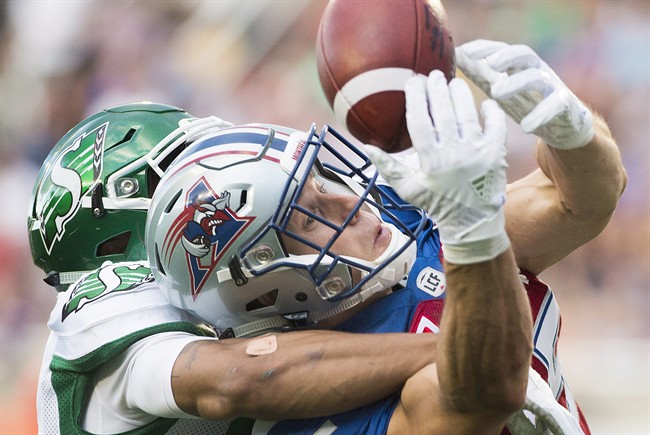 Montreal Alouettes' Samuel Giguere, right, and Saskatchewan Roughriders' Justin Cox go up for the ball during first half CFL football action in Montreal, Friday, July 29, 2016. THE CANADIAN PRESS/Graham Hughes