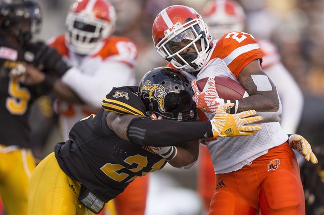 Simoni Lawrence (21) and the Hamilton Tiger-Cats will try to keep Jeremiah Johnson and the B.C. Lions in check Friday night in Vancouver.
