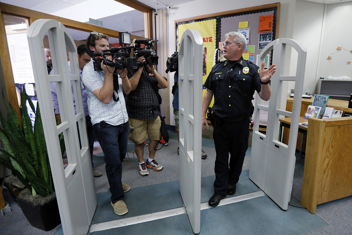 El Centro College Police Chief Joseph Hannigan walks into the schools library as he gives a guided tour to the media, Tuesday, July 19, 2016, in Dallas, retracing the path Micah Johnson took once he entered the downtown campus.