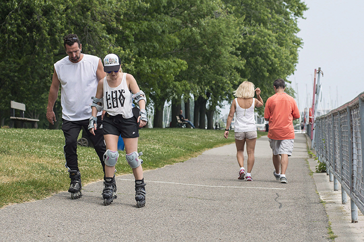 People enjoy the hot weather at Coronation Park, near Lake Shore Boulevard, in Toronto, Monday, June 20, 2016. 