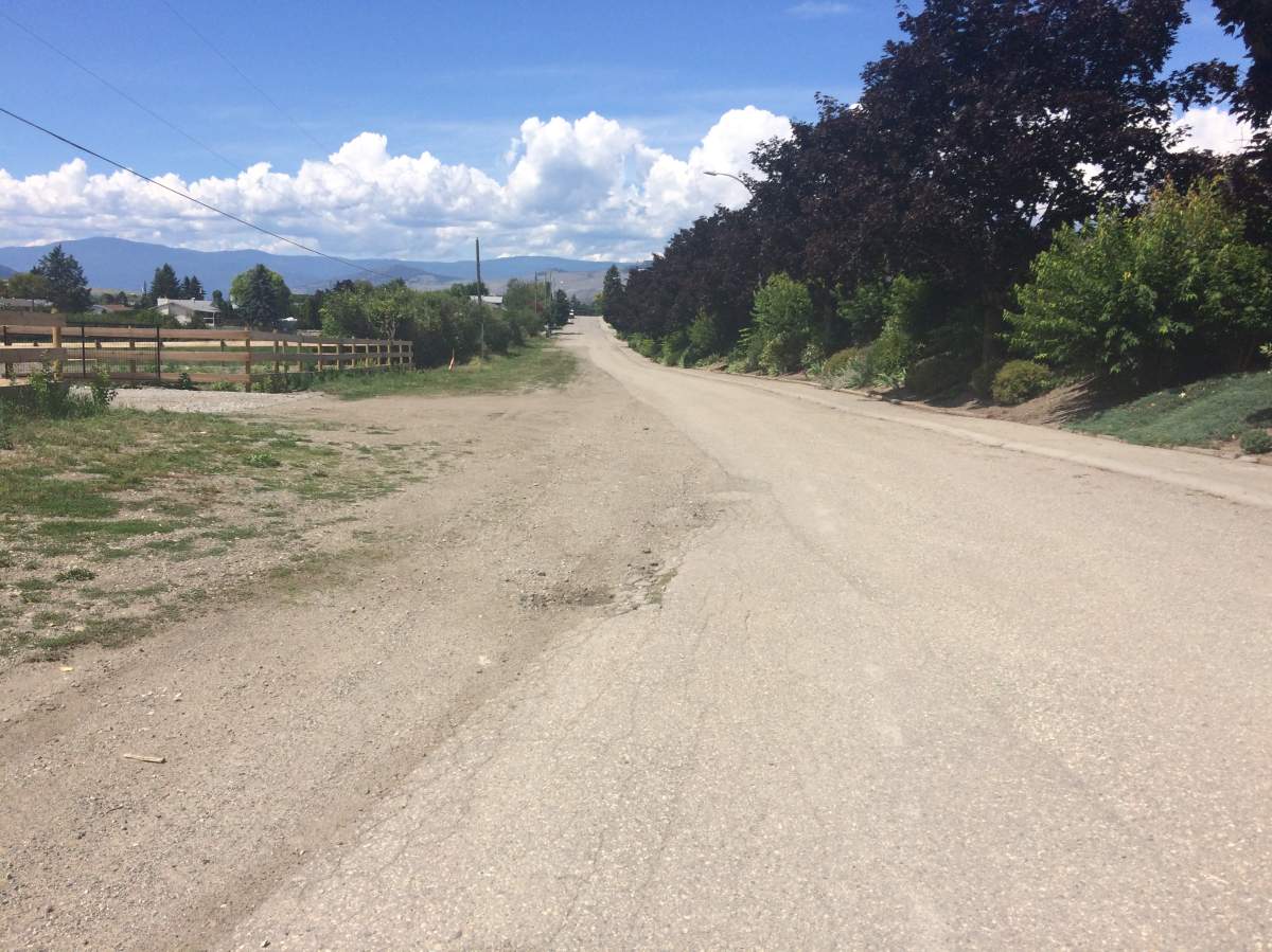 The street in question is Shantz Road. The pavement portion of the street is the city’s jurisdiction, while the grass and gravel area is the province’s responsibility.