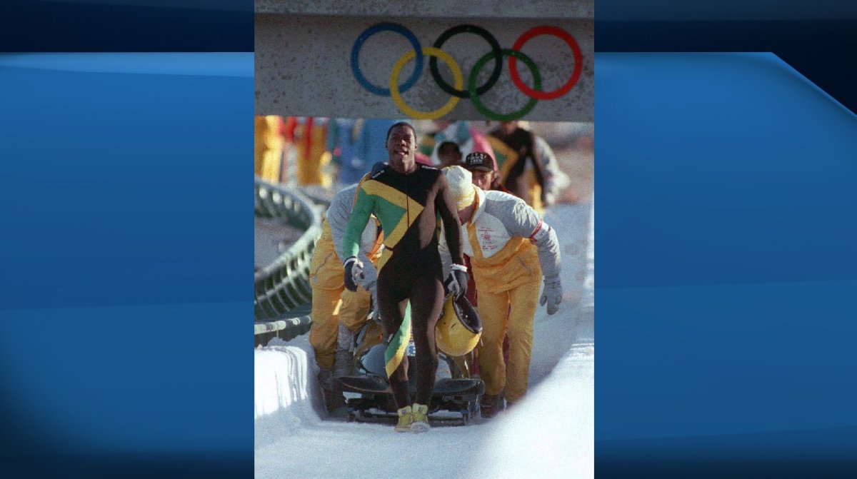 Members of the Jamaican four-man bobsled team walk up the course after wiping out during a run at the 1988 Winter Olympics in Calgary, Dec. 23, 1988. 