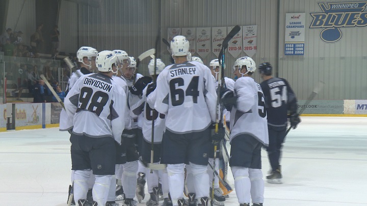 Team White celebrates a 6-5 overtime victory in the Winnipeg Jets intrasquad game.