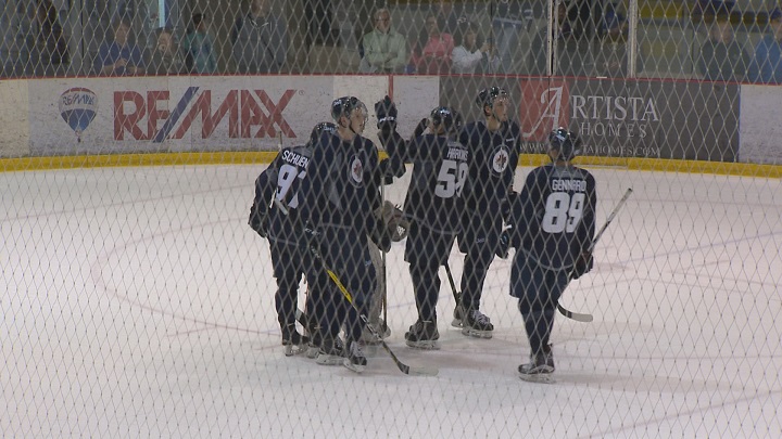 Team Blue celebrates a 6-4 win to conclude the Winnipeg Jets Development Camp.