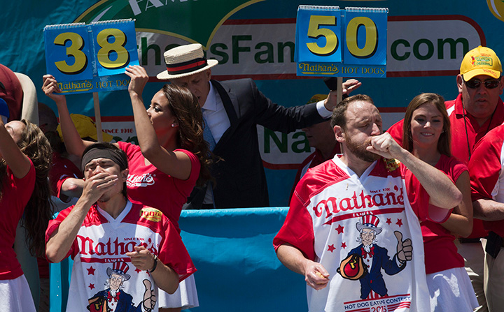 Matt Stonie, left, and Joey Chestnut compete in Nathan’s Famous Fourth of July International Hot Dog Eating Contest men’s competition, Monday, July 4, 2016, in New York.