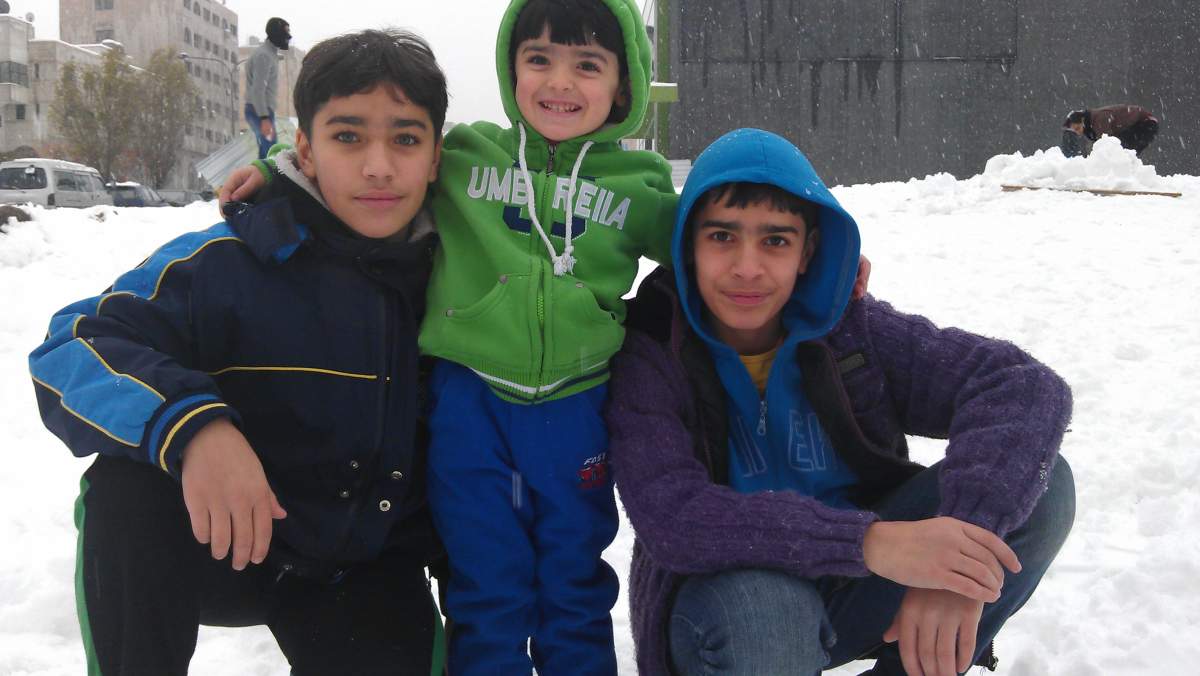 Muammar Sawwan’s children enjoying the snowfall in Jordan.