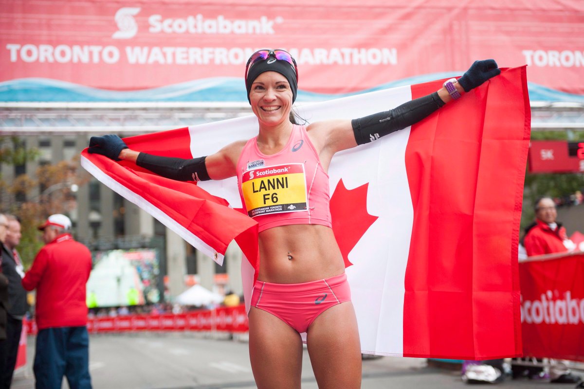Canadian Lanni Marchant celebrates after crossing the marathon finish line and qualifying for the 2016 Rio Olympics during the Scotiabank Toronto Waterfront Marathon in Toronto, Sunday, Oct, 18, 2015. 
