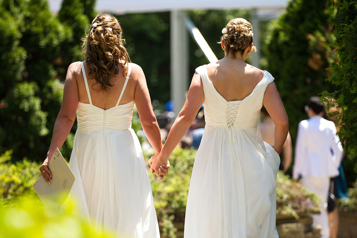 Cheryl Taylor and Jennifer Smith hold hands as they arrive for the Grand Pride Wedding, a mass gay wedding at Casa Loma in Toronto, Canada, on June 26, 2014. 