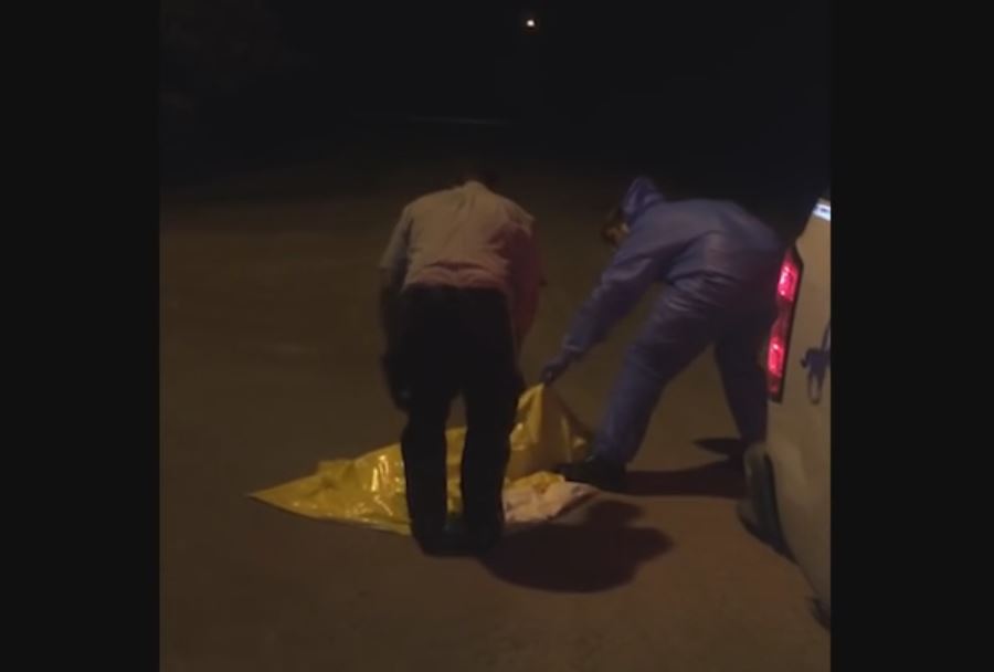 Two RCMP officers work to free a skunk on June 22. 