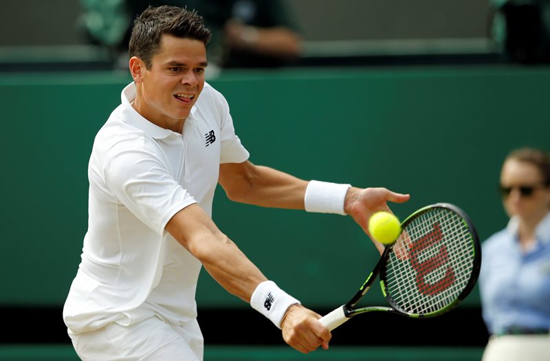 Milos Raonic of Canada returns to Sam Querrey of the U.S during their men's singles match on day ten of the Wimbledon Tennis Championships in London, Wednesday, July 6, 2016. 