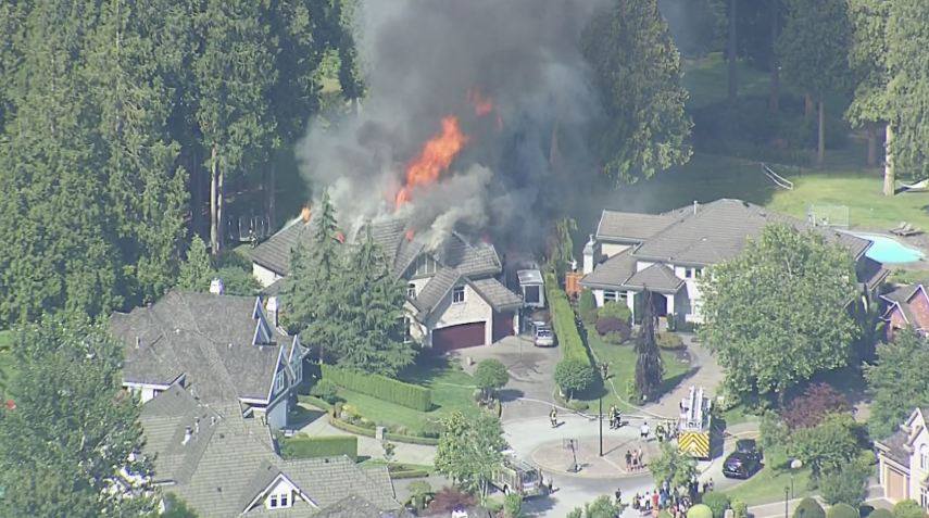 Flames engulfed a large home in North Surrey Wednesday afternoon.