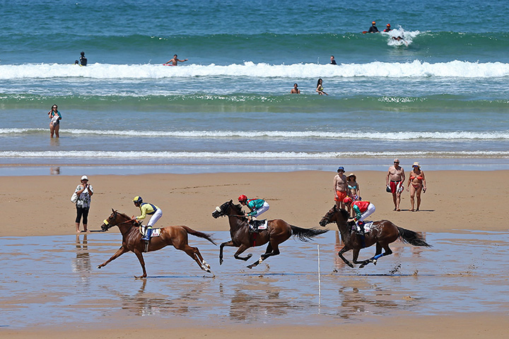 Jockeys race along the beach during the annual beach horse race in Loredo, near the northern Spanish city of Santander.