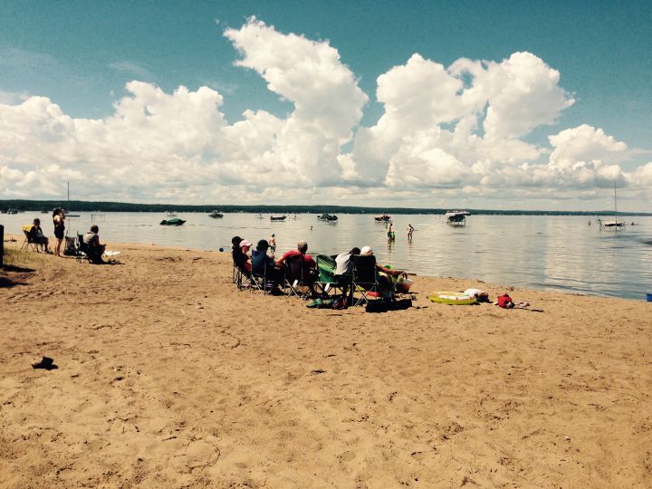 A group sits on Ma-Me-O Beach enjoying the weather on July 26, 2016.