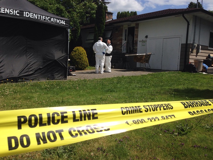 Police invetigators on the scene of a homicide in Chilliwack on July 14, 2016.