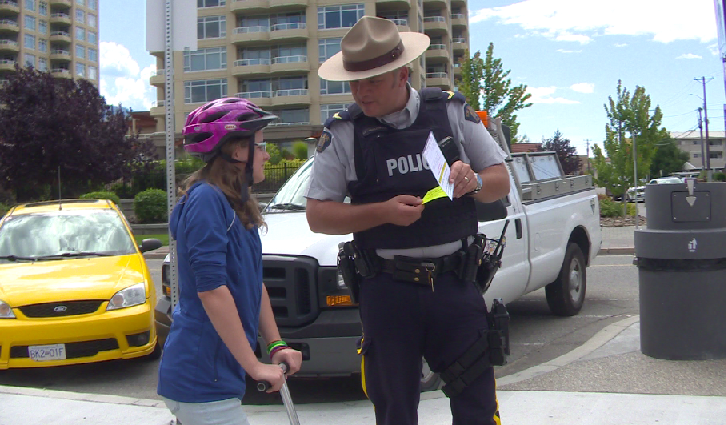 Penticton RCMP and community police officers hand out 'positive tickets' to people wearing helmets.