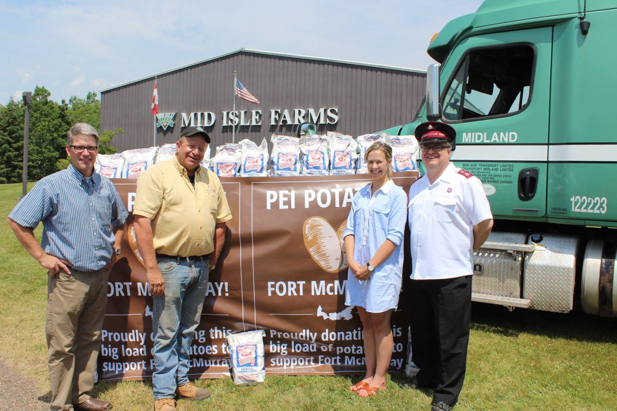 The PEI Potato Board is donating 50,000 pounds of potatoes to food banks in Fort McMurray. Pictured are Greg Donald , the general manager of the PEI Potato Board, Chairman Alex Docherty, Jennifer Harris of Mid-Isle Farms and Major Daniel Roode of the PEI Salvation Army.