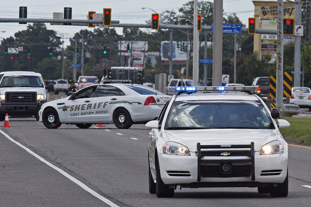 Baton Rouge Police arrive at the scene on Airline Highway after police were shot in Baton Rouge, La., Sunday, July 17, 2016. 