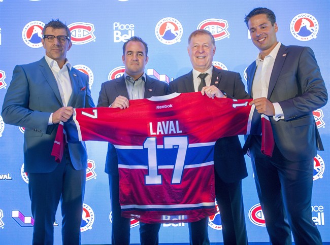 In this file photo, Montreal Canadiens general manager Marc Bergevin, left to right, team owner Geoff Molson, Laval Mayor Marc Demers and Place Bell manager Vincent Lucier pose for photos at a news conference Monday, July 11, 2016 in Laval, Quebec. The team announced they will move their American Hockey League affiliate, the St. John's IceCaps, to Laval for the start of the 2017 season.