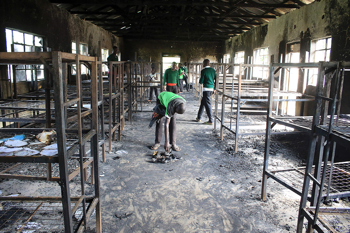 Students of St. Peter's-Nyamesocho in Kisii county rummage through a burnt-out dormitory for salvagable items on July 07, 2016, after it was set on fire by some of the students during a night of unrest.