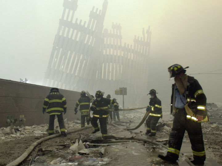  In this Sept. 11, 2001, file photo, firefighters work beneath the destroyed mullions, the vertical struts which once faced the soaring outer walls of the World Trade Center towers, after a terrorist attack on the twin towers in New York.  (File photo).