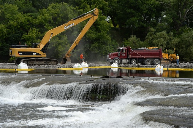Construction workers start on a hydro dam expansion on the Mississippi River in Almonte, Ont., on Friday, July 15, 2016. 