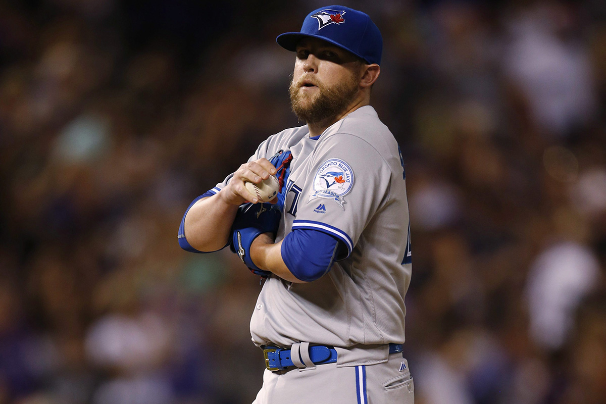 Toronto Blue Jays relief pitcher Drew Storen reacts after giving up a single to drive in two runs to Colorado Rockies' Nolan Arenado in the seventh inning of a baseball game Monday, June 27, 2016, in Denver. Colorado won 9-5. 