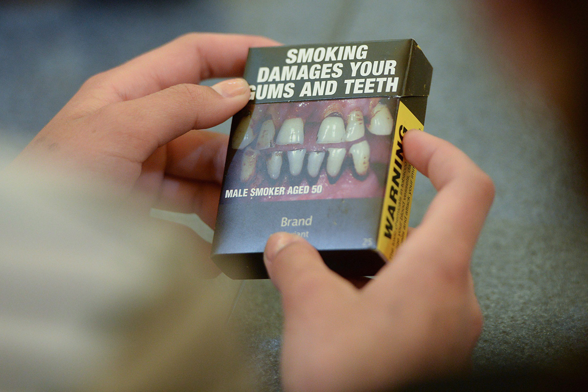 Local Ottawa high school students look at plain cigarette packaging examples, on World No Tobacco Day, prior to meeting with Minister of Health Jane Philpott in Ottawa on Tuesday, May 31, 2016. 