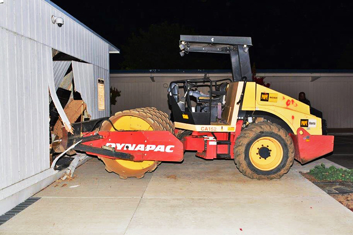 This Sunday, July 17, 2016 photo provided by the Fresno, Calif., Police Department shows a tractor that had been stolen by three juvenile runaways and crashed into a school building in Fresno on Sunday. 