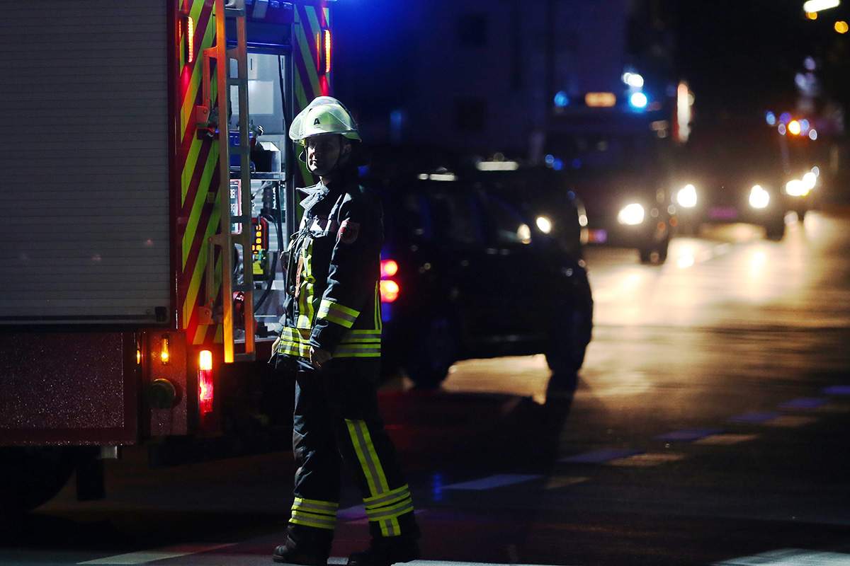 A firefighter stands at a road block in Wuerzburg, southern Germany, Monday evening July 18, 2016.