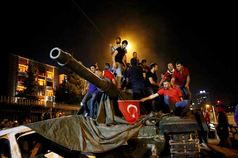 People stand on a Turkish army tank in Ankara, Turkey July 16, 2016. REUTERS/Tumay Berkin