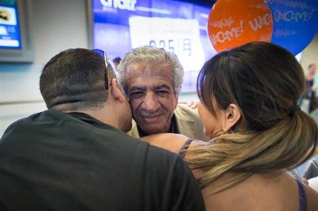 Iranian-Canadian sculptor Pardiz Tanavoli, centre, who was barred from leaving Iran after his passport was seized on July 2, is greeted by his son Bardia Tanavoli, left, and his daughter Tandar Tanavoli after he arrived at Vancouver International Airport in Richmond, B.C., on Monday, July 18, 2016. 