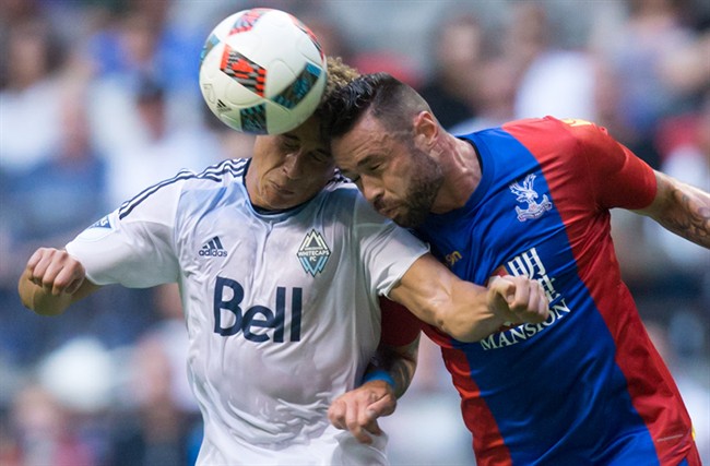 Vancouver Whitecaps' Erik Hurtado, left, and Crystal Palace's Damien Delaney vie for the ball during the first half of an international friendly soccer game in Vancouver, B.C., on Tuesday July 19, 2016.