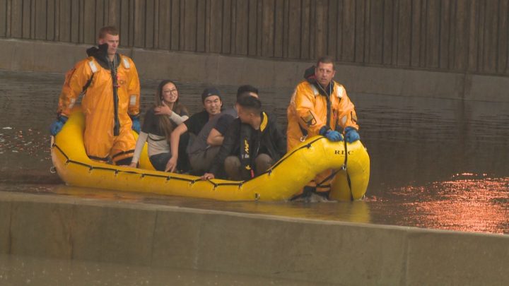 A group of friends is rescued from Whitemud Drive after a summer storm floods the freeway.