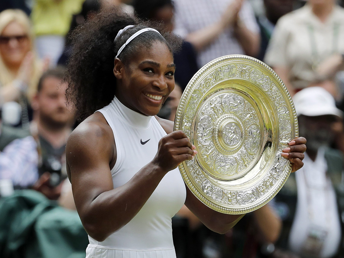 Serena Williams of the U.S holds her trophy after winning the women's singles final against Angelique Kerber of Germany on day thirteen of the Wimbledon Tennis Championships in London, Saturday, July 9, 2016. 